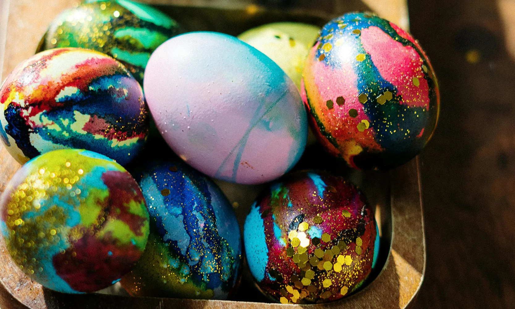 Colourful decorated Easter eggs in a wooden tray for a spring celebration