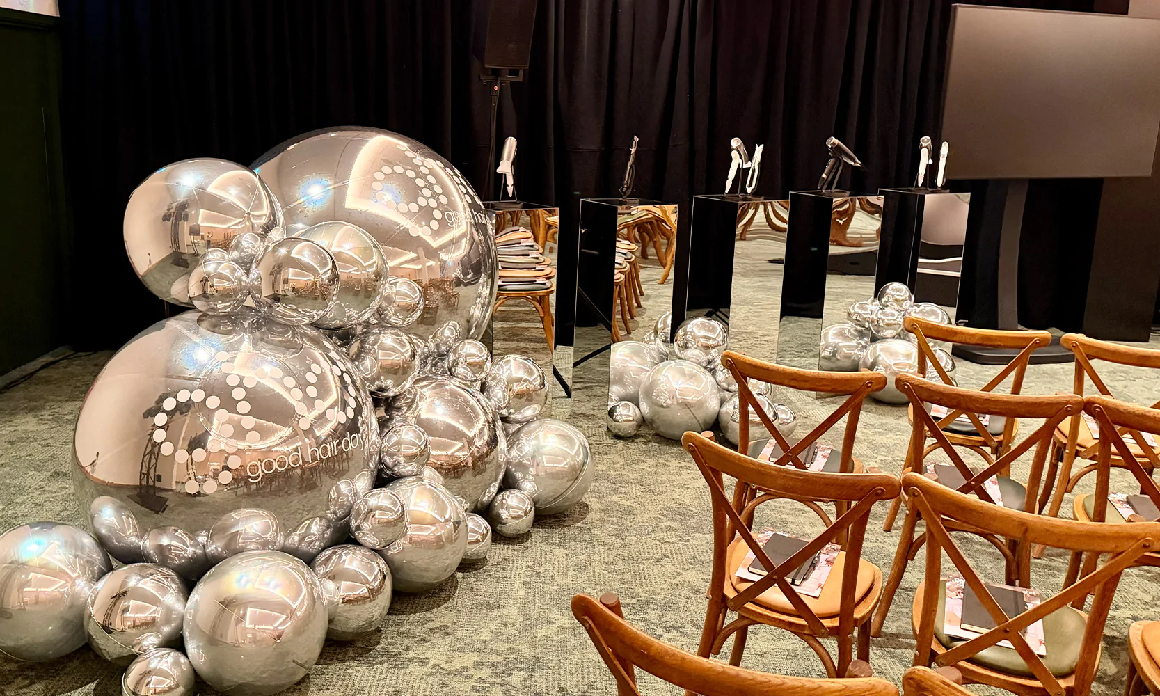 Custom branded silver spheres for a GHD corporate event.