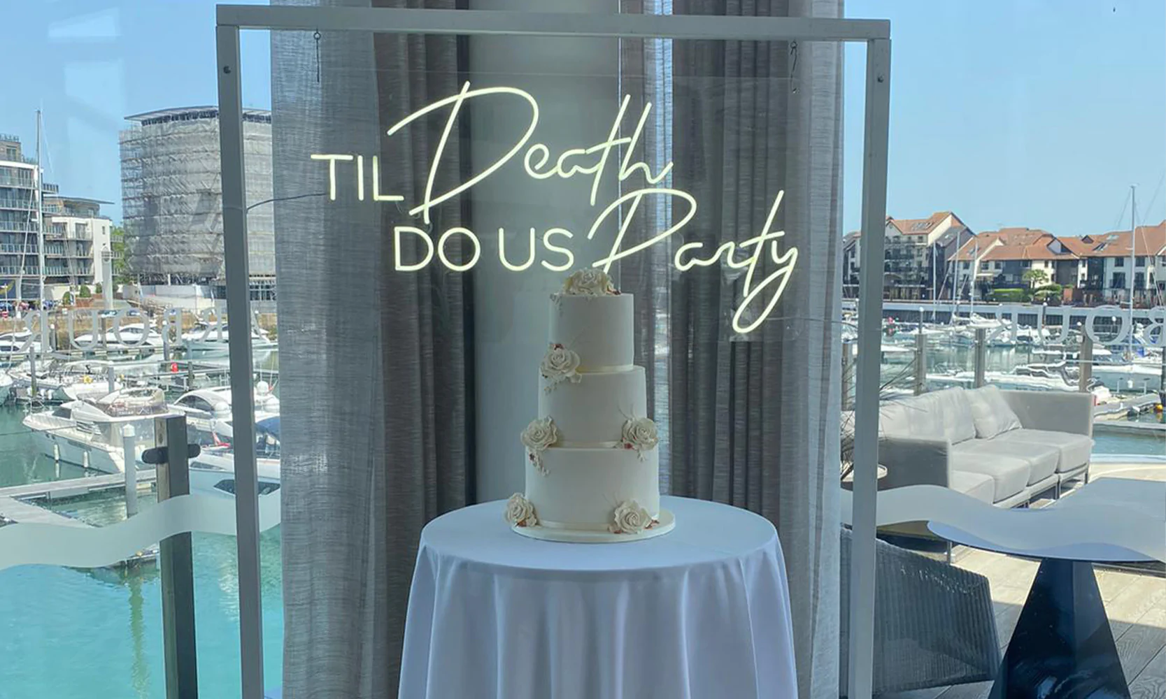 Til Death Do Us Party Neon Sign with a wedding cake.
