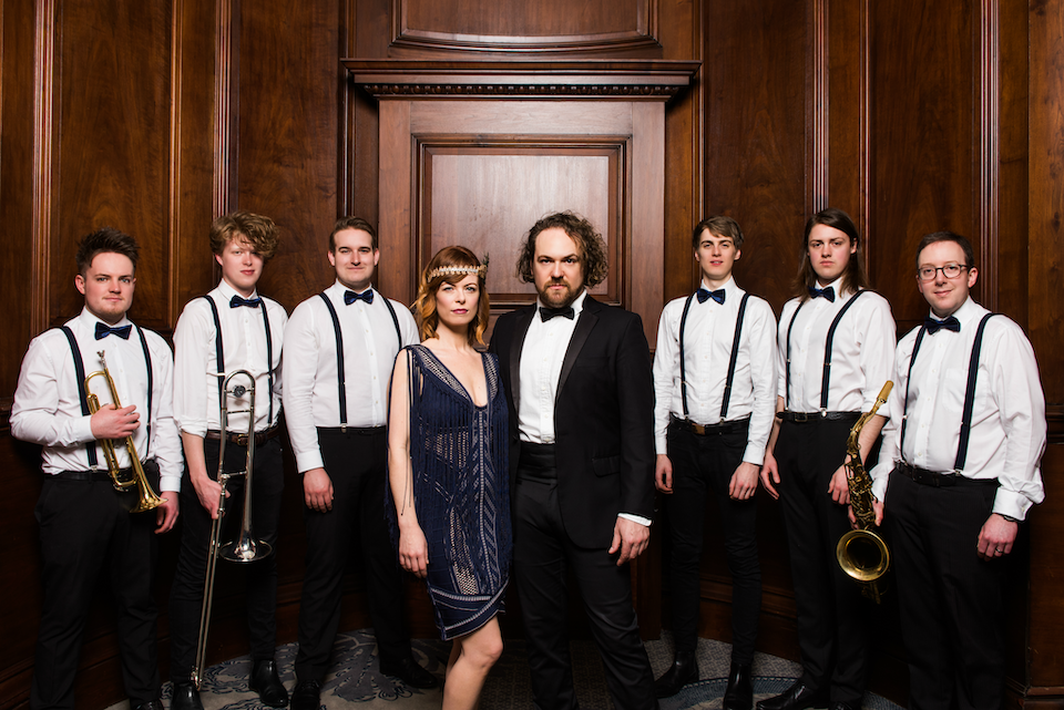 Smartly dressed band posing with their instruments